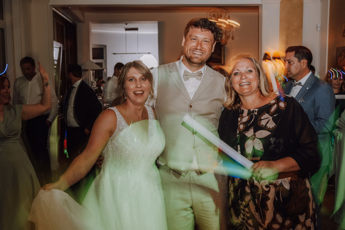 Wedding guests dancing in the covered outdoor area at Villa Renting Eisenberg, Palatinate